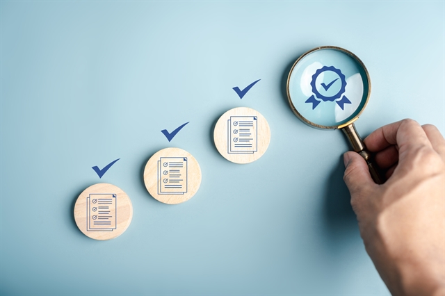 Certificate approval process with document checklist, magnifying focus quality assurance, verification system, compliance audit, and standard validation. stock photo