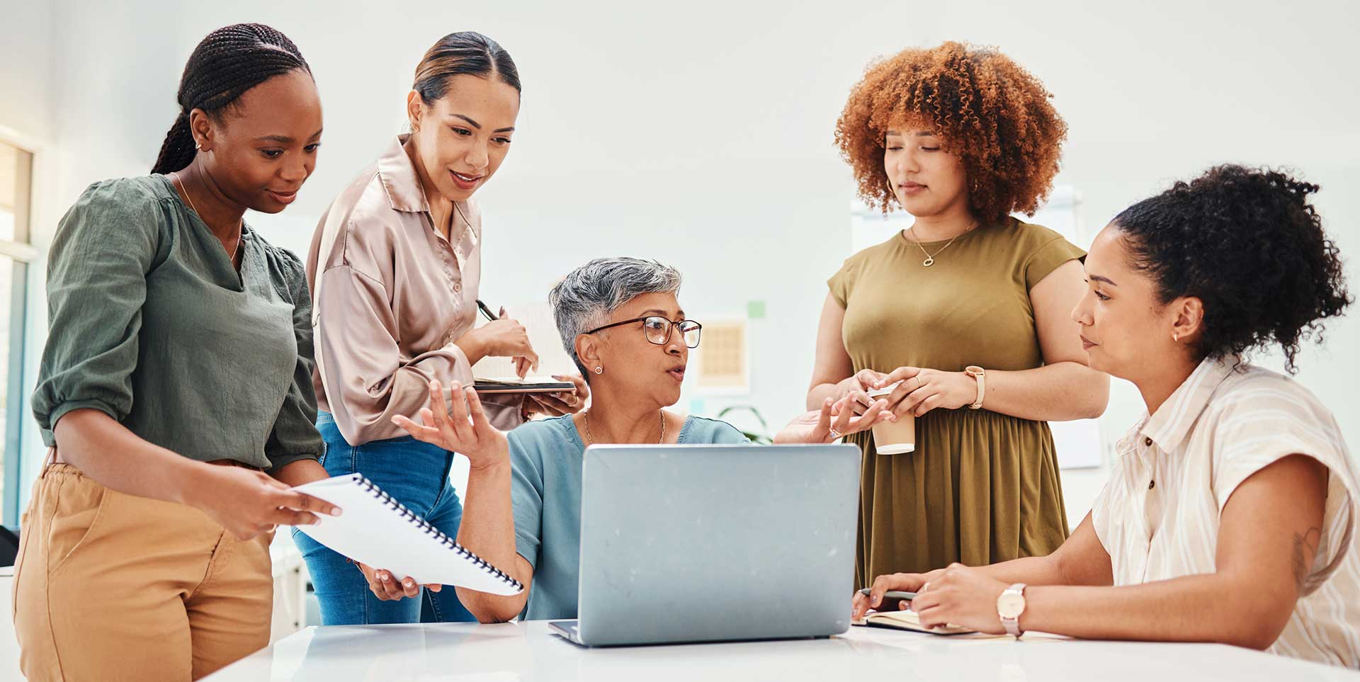 laptop discussion with professional female coworkers